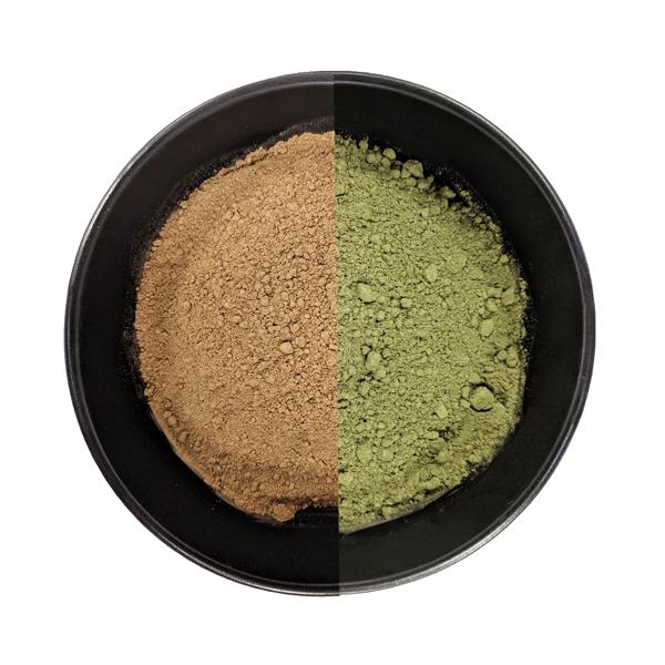 A black bowl containing two types of Pain Blend is perfectly divided: brown powder on the left and green powder on the right, blending harmoniously.